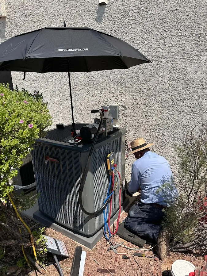 HVAC technician performing outdoor AC maintenance in Poolesville